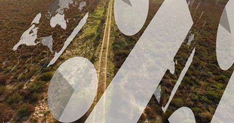 Drone view of dirt track crossing semiarid scrub with percent symbols and map overlay