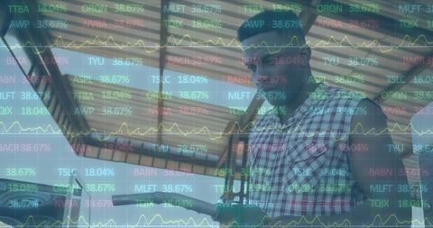 African worker at gas station analyzing financial charts