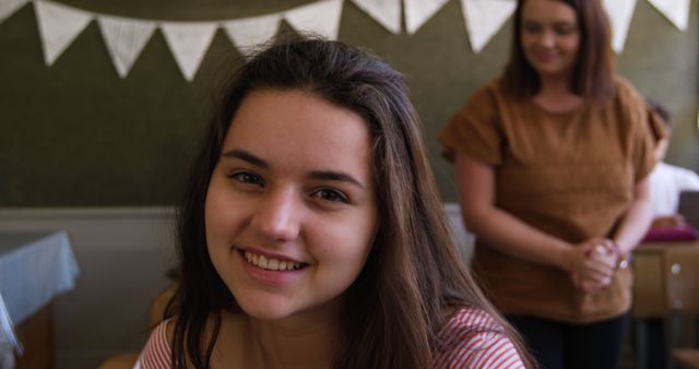 Smiling Young Woman with Mentor in Background - Download Free Stock Images Pikwizard.com