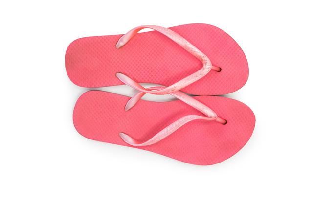 Pair of pink beach flip flop slipper on white background