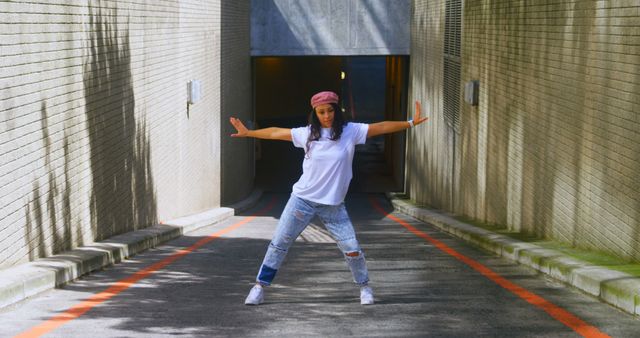 Young Woman in Casual Outfit Dancing in Urban Alley - Download Free Stock Images Pikwizard.com