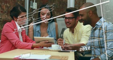 Diverse Team Collaborating in Modern Workspace with Tablet and Notepad