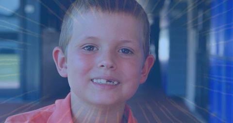 Cheerful Schoolboy Posing with Radiant Light Streaks in Hallway