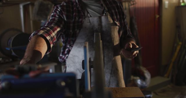 Man Working in a Workshop with Apron and Tools - Download Free Stock Images Pikwizard.com