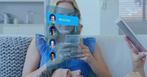 Blonde woman using smartphone with augmented reality contacts overlay on cozy sofa