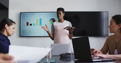 Businesswoman Presenting Statistical Data in Office Meeting - Download Free Stock Images Pikwizard.com