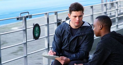 Mentoring session outdoors between tutor and student