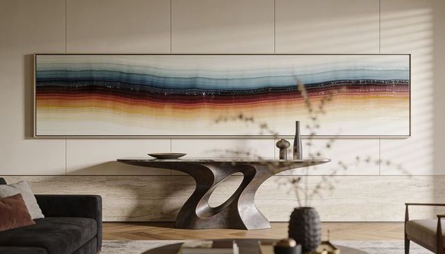 Sculptural console anchoring sunlit minimalist living room with panoramic abstract wall art