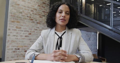 Confident biracial businesswoman in modern office setting