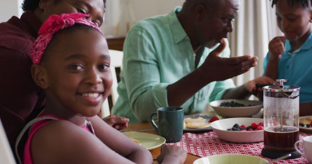 Smiling Girl at Breakfast Table with Family - Download Free Stock Images Pikwizard.com