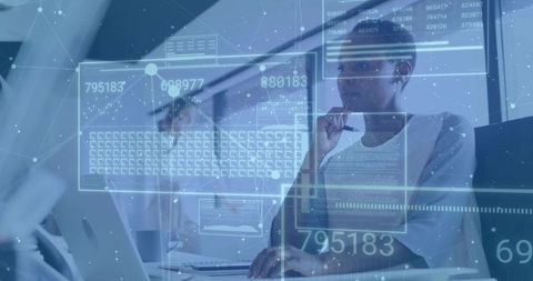 Office Analyst Studying Data with Technology Overlays