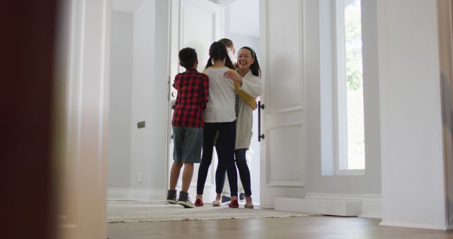 Family members reuniting at home, hugging with excitement at entrance. Ideal for depicting warmth in family relationships and homecoming celebrations.