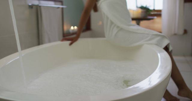 This image might be used to portray relaxation and self-care in personal care advertisements, wellness blogs, magazines, or home decor websites. It can also promote luxury bath products.