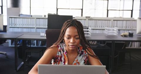Professional Woman Focused on Laptop Work in Modern Office - Download Free Stock Images Pikwizard.com