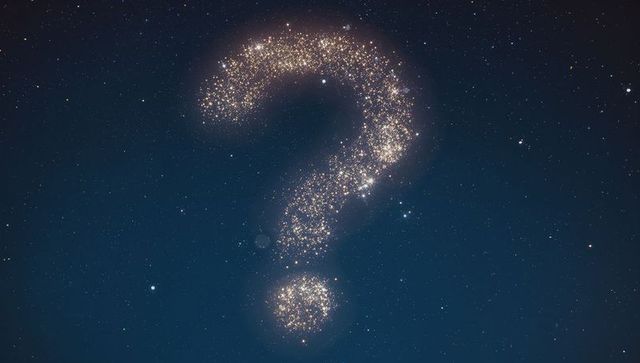 Golden cosmic question mark amid starry night sky