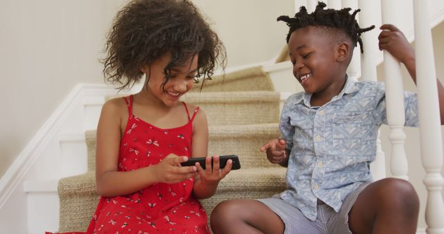 Happy Children Sharing Mobile Phone on Staircase - Download Free Stock Images Pikwizard.com