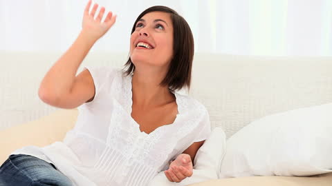 Smiling Woman Relaxing in Light Room