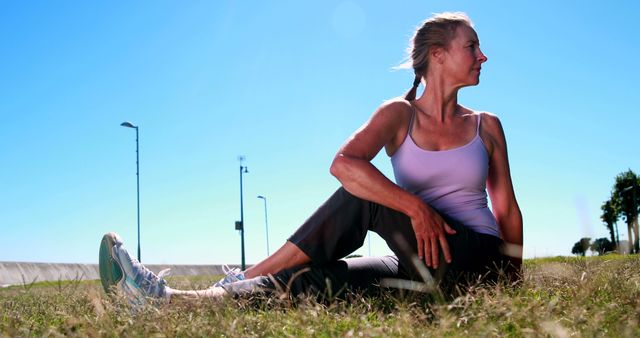 Mid-Aged Woman Stretching Outdoors on Sunny Day - Download Free Stock Images Pikwizard.com