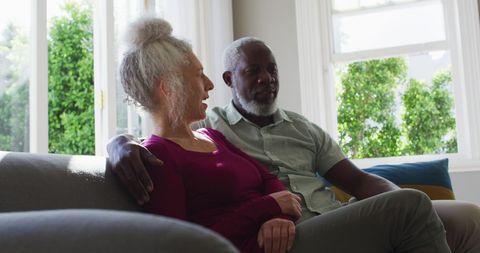 Senior Couple Relaxing on Couch in Sunlit Living Room - Download Free Stock Images Pikwizard.com