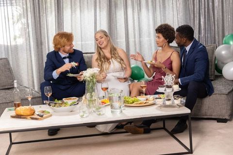 Elegant wedding reception with diverse friends sharing appetizers