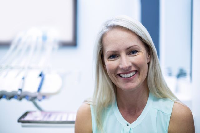 Portrait of female patient smiling in dental clinic