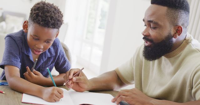 Father Helping Son with Homework in Bright Living Room - Download Free Stock Images Pikwizard.com