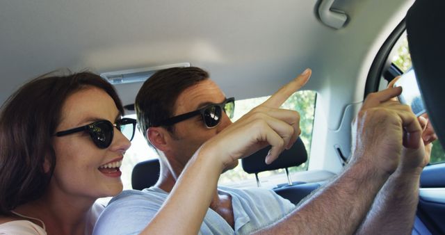 Happy Couple in Car Pointing at Sights During Road Trip - Download Free Stock Images Pikwizard.com