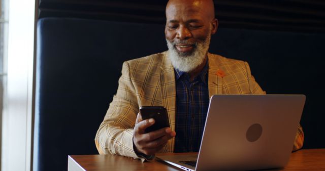 Smiling Senior Man Using Smartphone and Laptop in Cafe - Download Free Stock Images Pikwizard.com