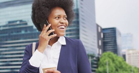 Confident African American Businesswoman Using Smartphone Outdoors