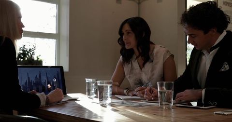 Business Team Meeting with Charts and Notes in Modern Office