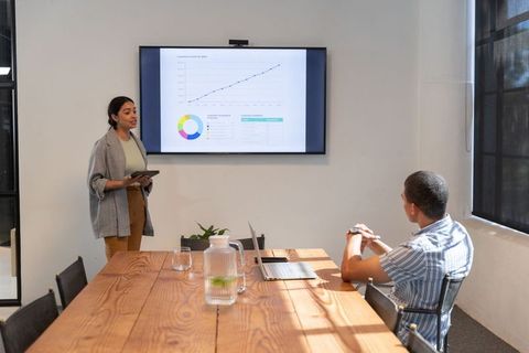 Diverse Team Collaboration in Modern Workspace with Presentation