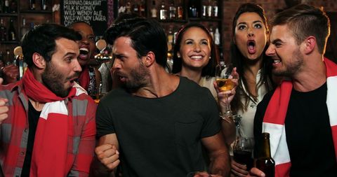 Group of Friends Enjoying Night Out at Lively Bar