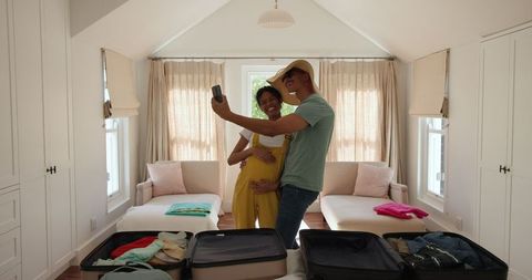 Excited couple packing suitcases ready for vacation