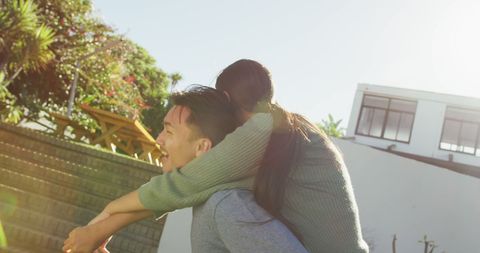Happy Couple Embracing Outdoors in Sunlit Garden - Download Free Stock Images Pikwizard.com