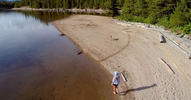 Child Playing on Sandy Beach by Calm Lake - Download Free Stock Images Pikwizard.com