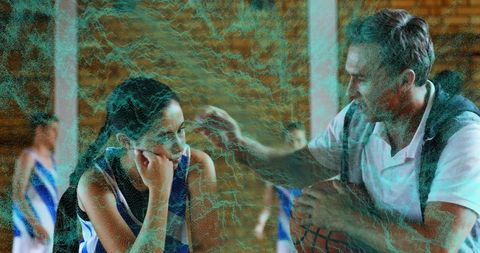 Coach Encouraging Teen Basketball Player on Sideline