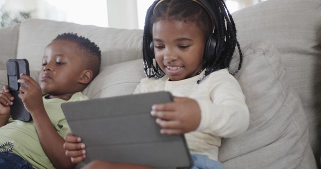 Children Using Digital Devices on Couch at Home - Download Free Stock Images Pikwizard.com