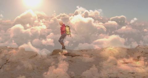 Hiker Above Clouds on Mountain Ledge at Sunset