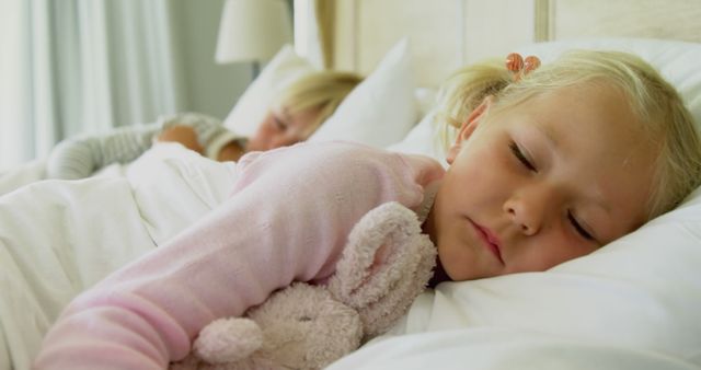 Young Girl Sleeping Peacefully Cuddling Stuffed Animal in Bed - Download Free Stock Images Pikwizard.com