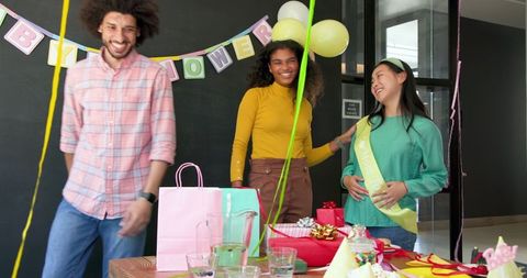 Colleagues Celebrate Baby Shower with Decorations and Gifts in Office