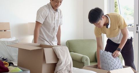 Two men packing belongings for home move