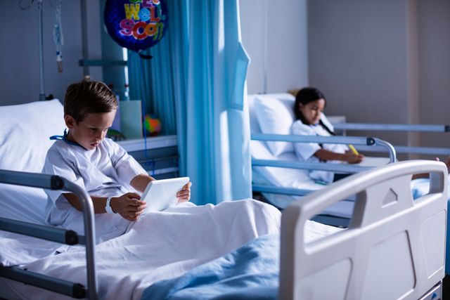 Children sitting on hospital beds, one using a digital tablet and the other reading a book. Ideal for illustrating pediatric healthcare, hospital environments, patient recovery, and the integration of technology in medical care.