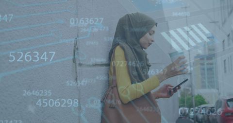 Woman in Hijab Using Smartphone with Digital Overlay