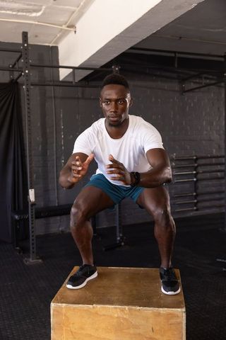 Determined athlete focusing on jump squat