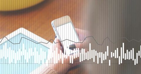 Hands using smartphone and tablet with overlaid data chart