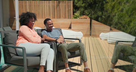 Couple Relaxing by Pool in Sunny Outdoor Setting