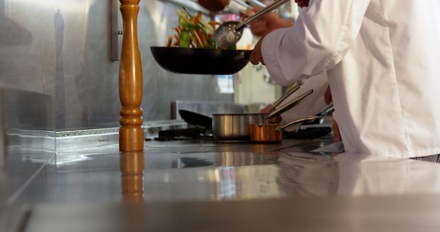 Chefs Cooking and Flipping Vegetables in a Professional Kitchen - Download Free Stock Images Pikwizard.com