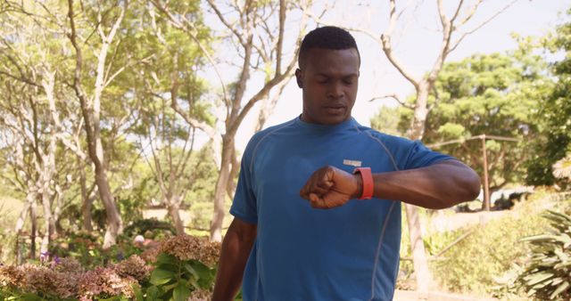 Man in Blue Sportswear Using Smartwatch in Nature Park - Download Free Stock Images Pikwizard.com