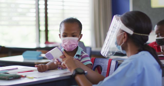 Health Worker Taking Temperature of Schoolgirl in Classroom - Download Free Stock Images Pikwizard.com