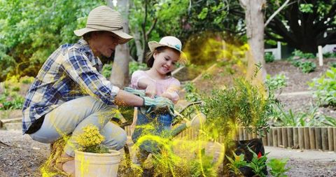 Mother and daughter gardening together with watering can